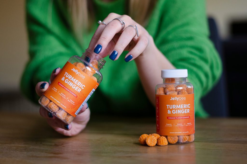 person holding orange labeled bottle